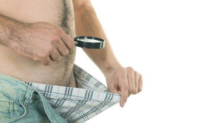 a man looks inside his underwear and thinks about enlarging his penis with soda